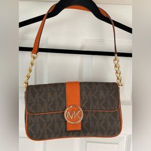 Michael Kors monogram purse with orange and gold details